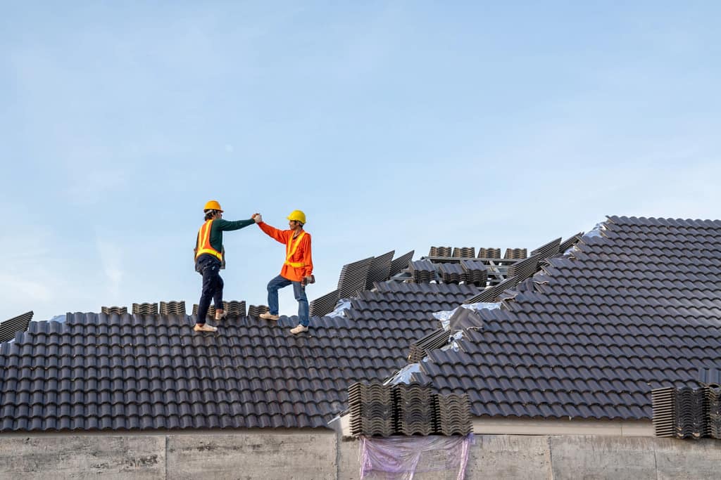 installing a new house roof as teamwork