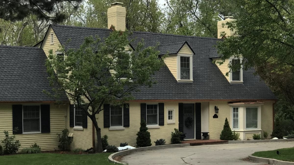 Beautiful home with f-wave gray shingles on roof