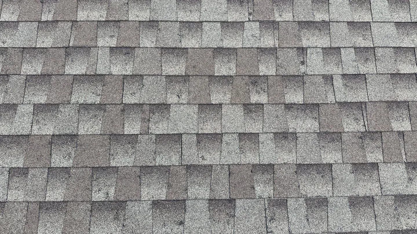 Hail damage on a gray shingle roof in need of storm damage roof repair