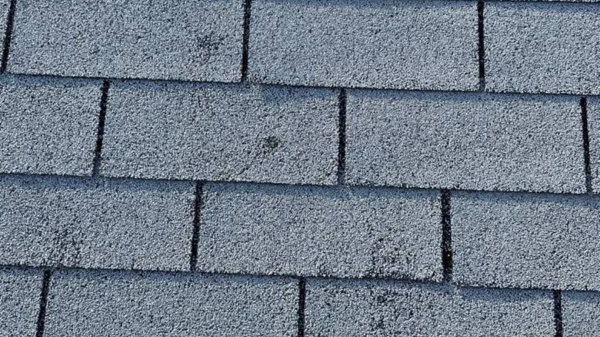 A roof exhibiting pre-loss conditions due to hail and storm damage