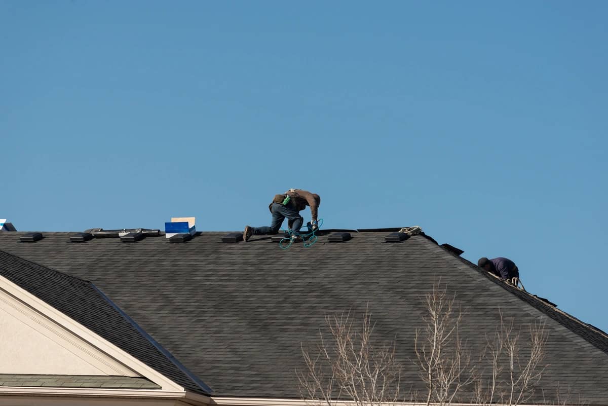 workers repairing the house roof