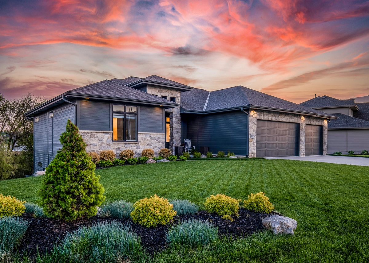new roof on a nice home with sunset in the background