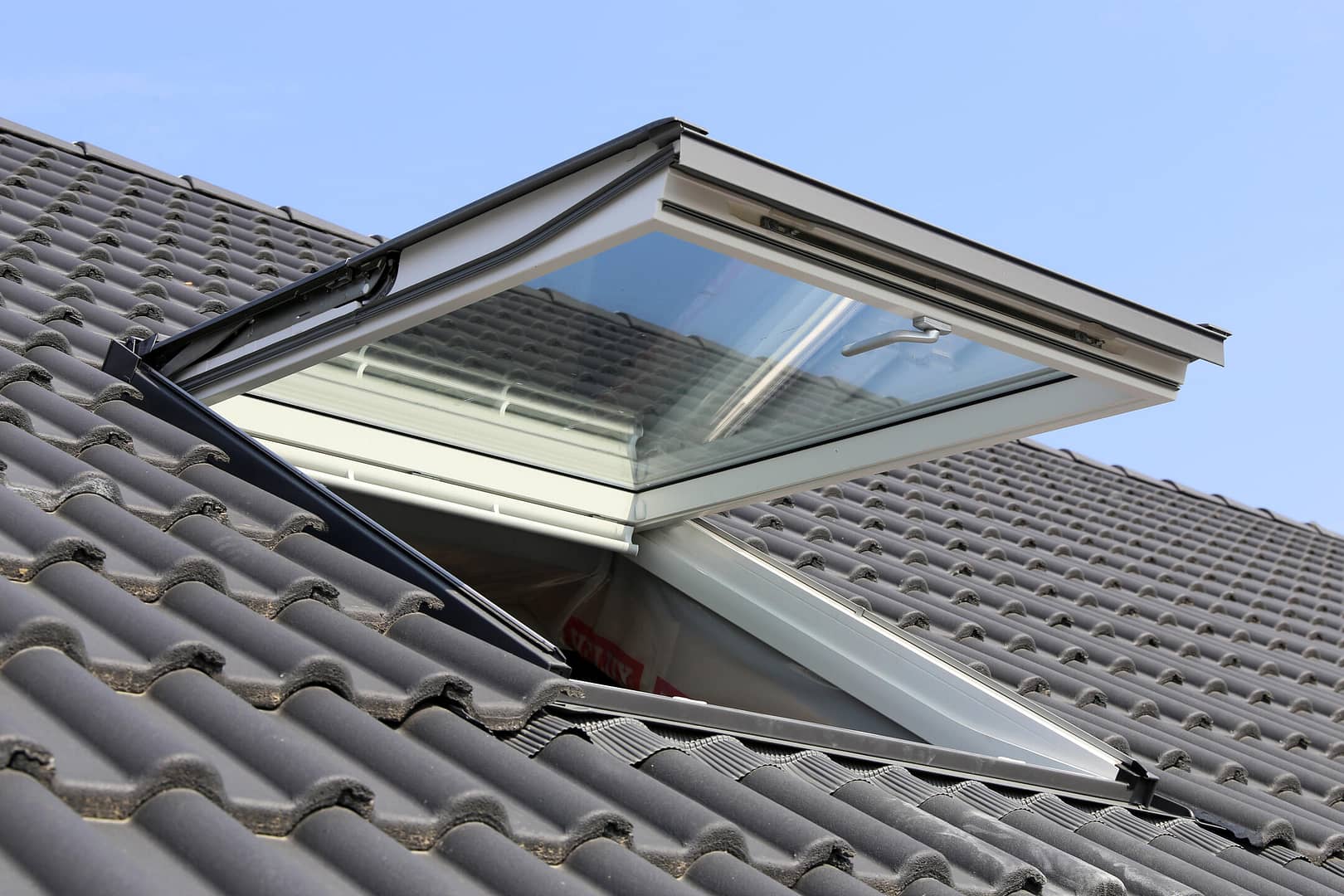 skylight installation-ventilated skylight on a tiled roof