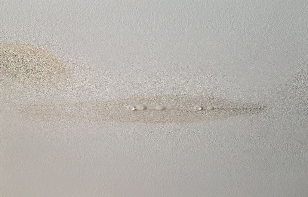 leaking roof repair water drops with white ceiling