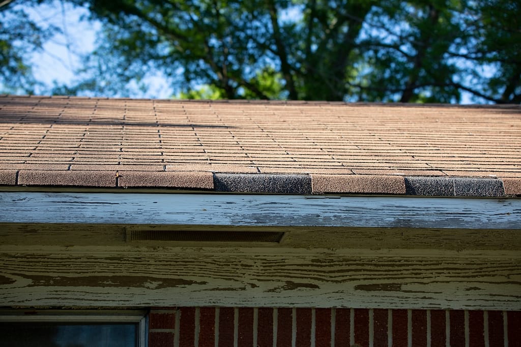 Close up of a roof line with missing shingles
