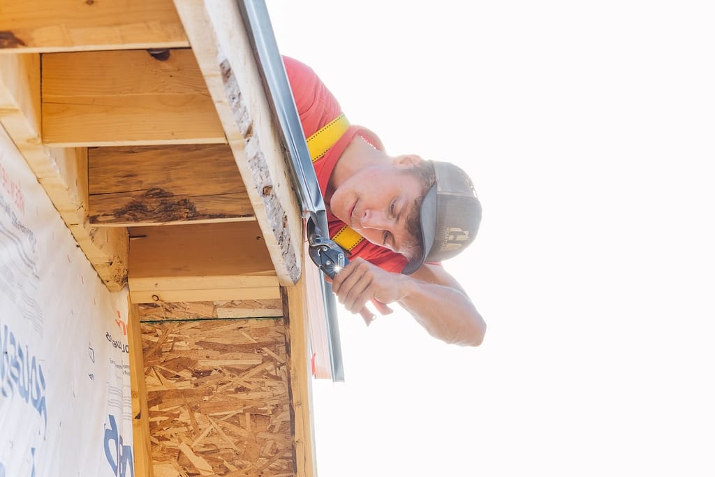Heartland worker installing gutters
