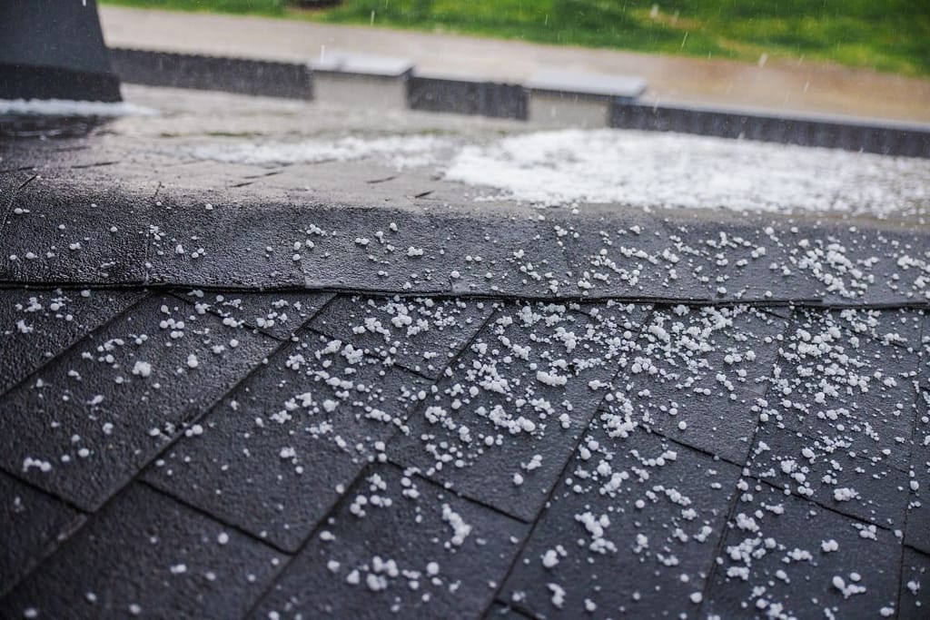 hail damage roof repair ice pieces on top of shingles
