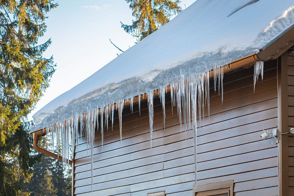 leaking roof repair ice on top brown siding