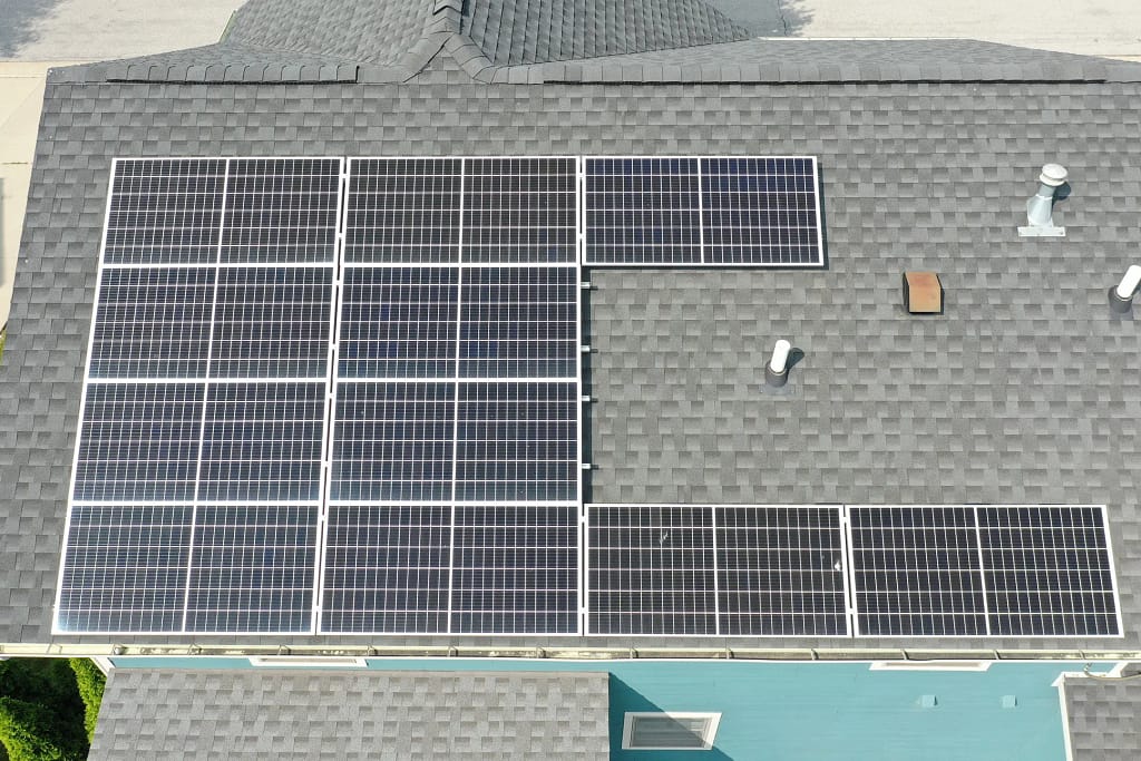 commercial roofing companies in ankeny aerial view of shingles roof with solar panels