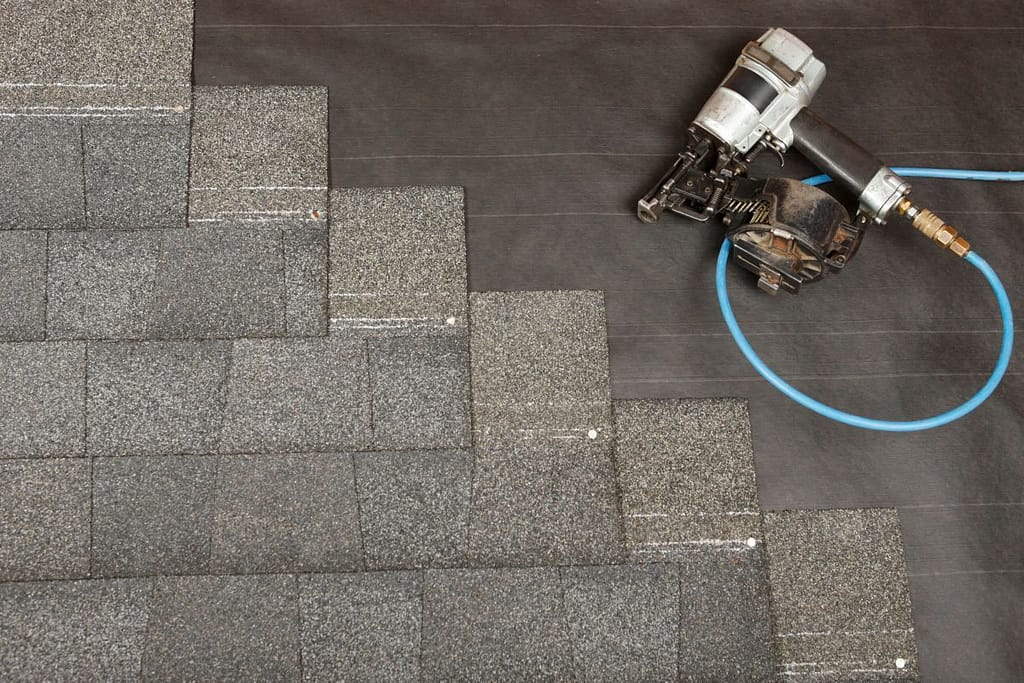 A shingle roof being installed