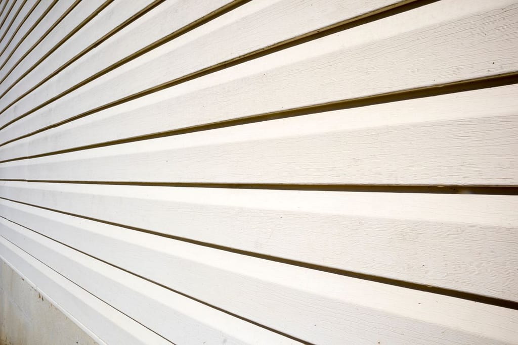 House with pale yellow vinyl siding, James Hardie Siding