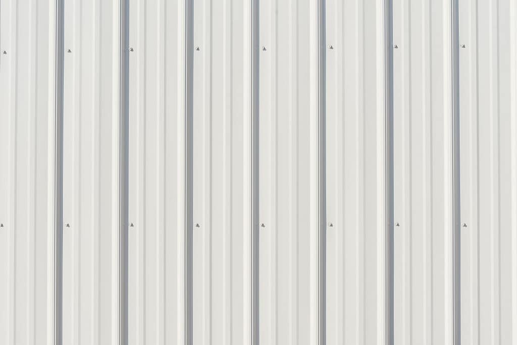 Light gray metal siding with shadows