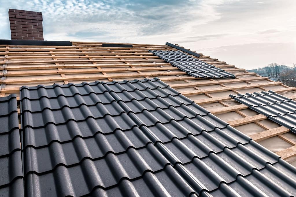 metal roof shingles being installed