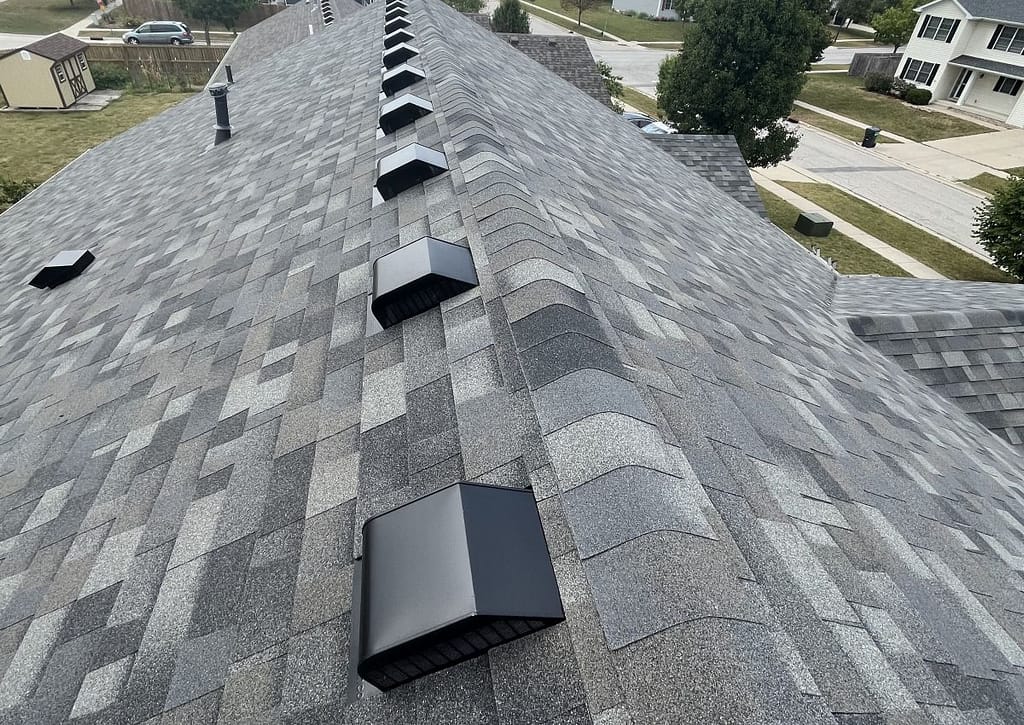 dark grey shingles on a roof with vents