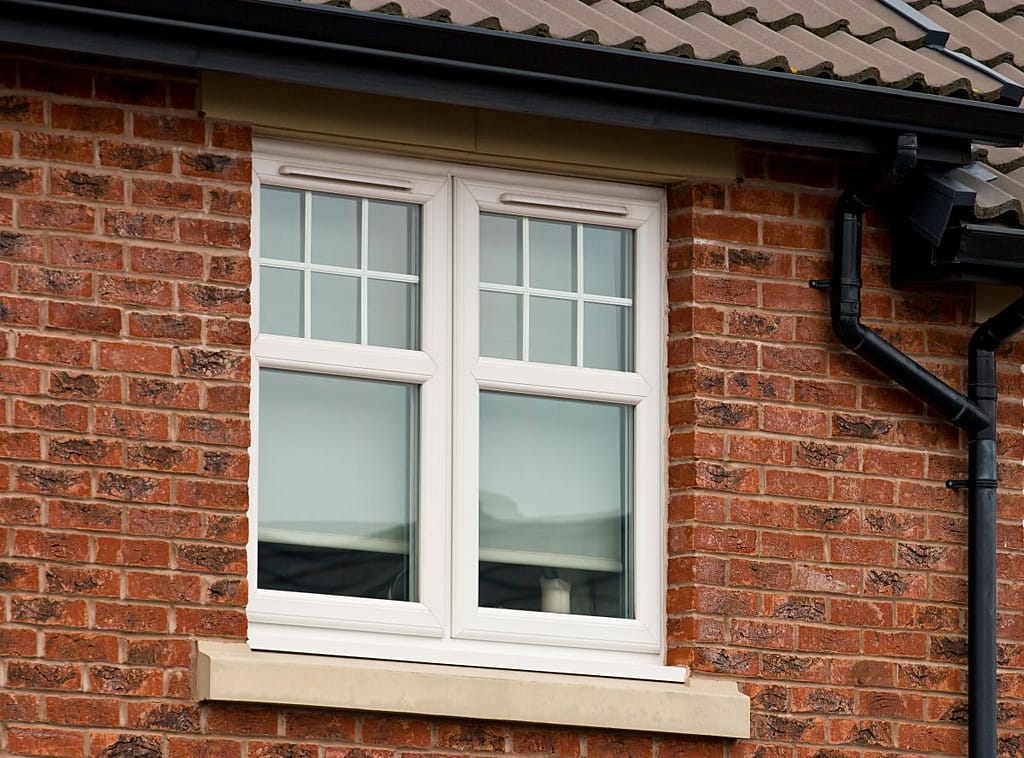 energy efficient windows white frame orange brick wall