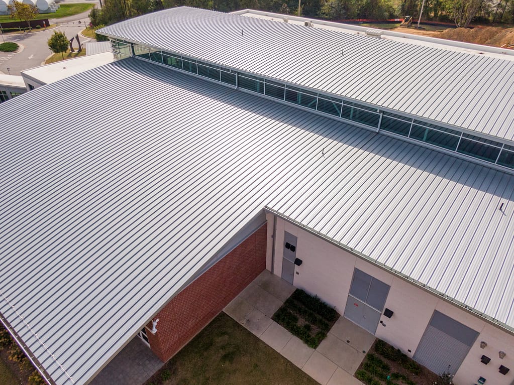 Sunny Daytime Drone Images of a New Commercial Building With A Large Standing Seam Metal Roofing System