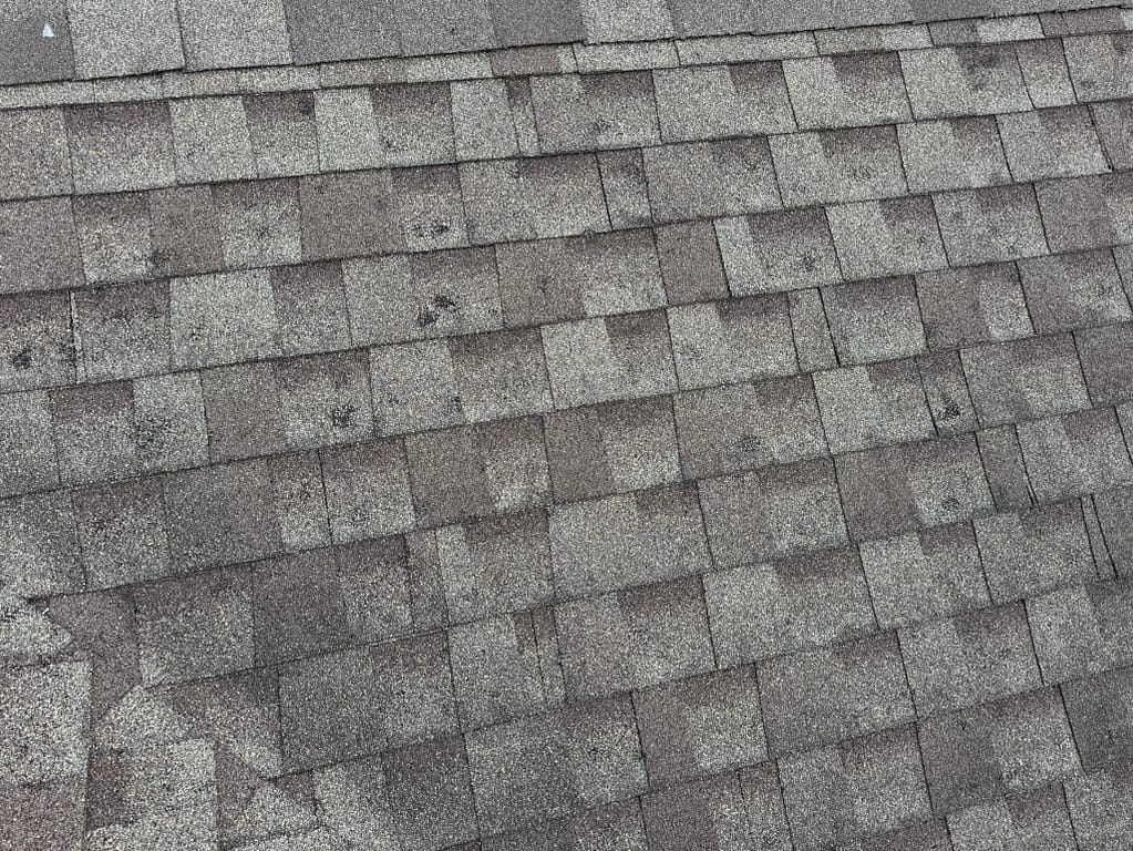 hail damage roof repair grey shingles with small holes