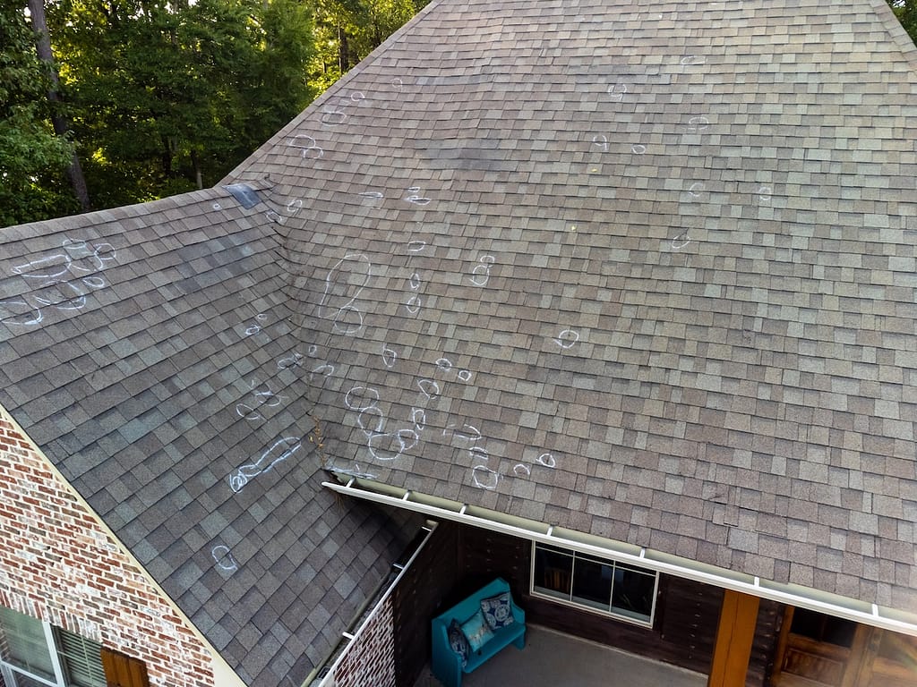Roof with hail damage and chalk markings from inspection