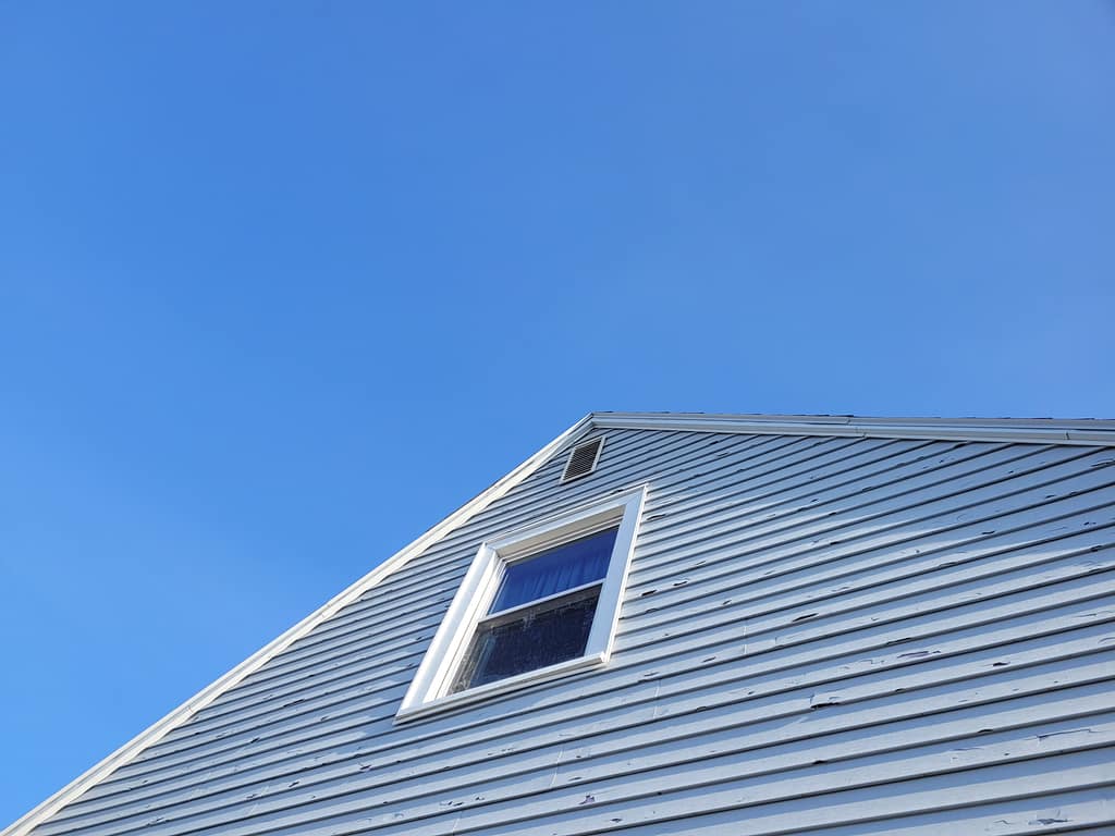 Hail cracked vinyl siding on an Iowa home after a storm.