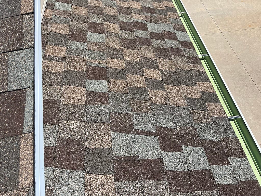 seamless gutter installation multicolored shingles roof