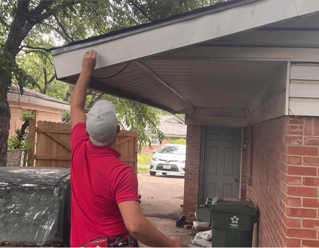 Roofer installing new fascia nad soffit on roof