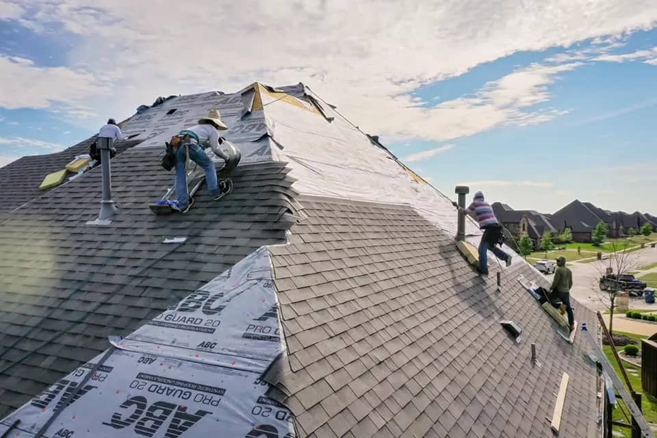professional roofing crew replacing house roof
