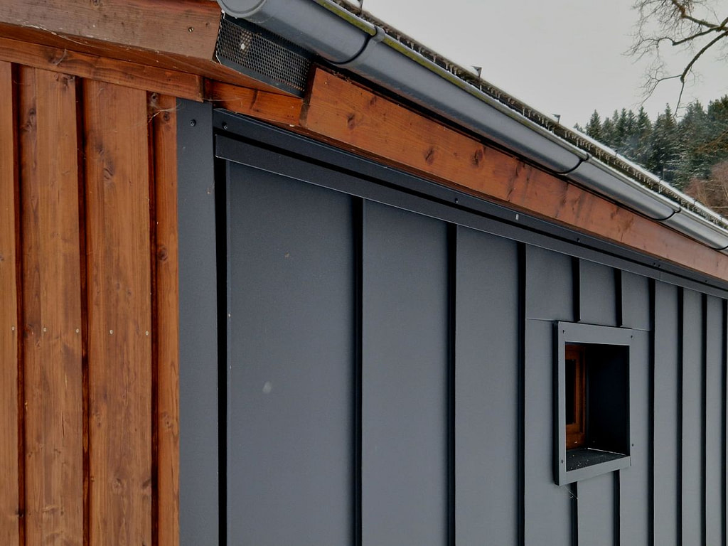 dark grey steel siding wooden roof
