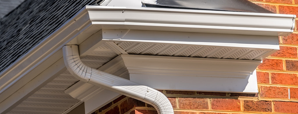 Soffit vents on the roof overhang, providing attic ventilation near the gutter corner
