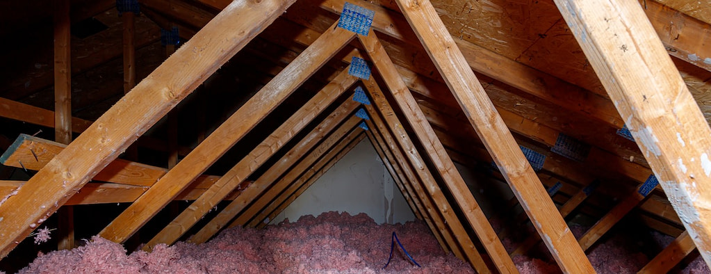 Wooden beams with Blown-In Insulation Contractor