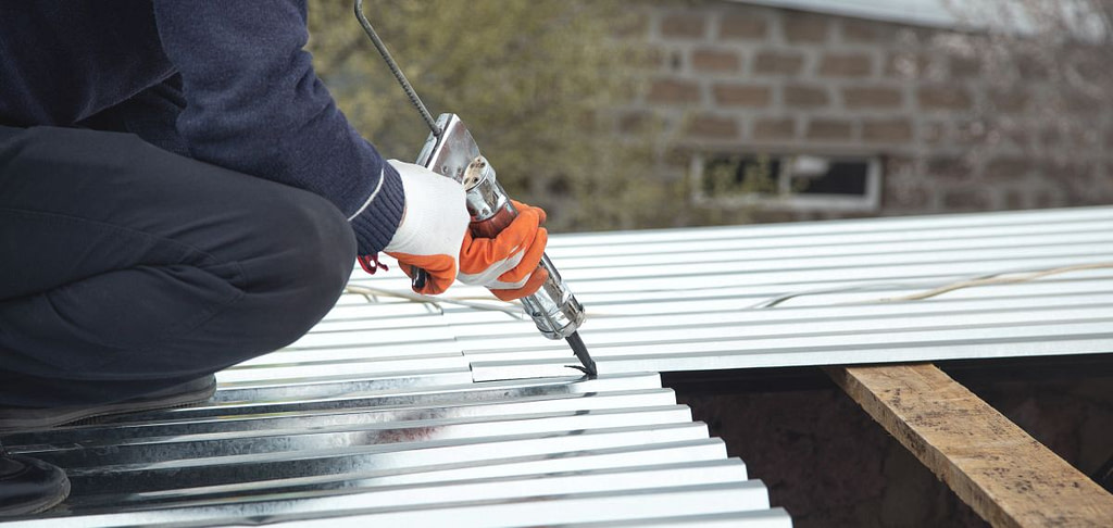 a metal roof sealant being applied
