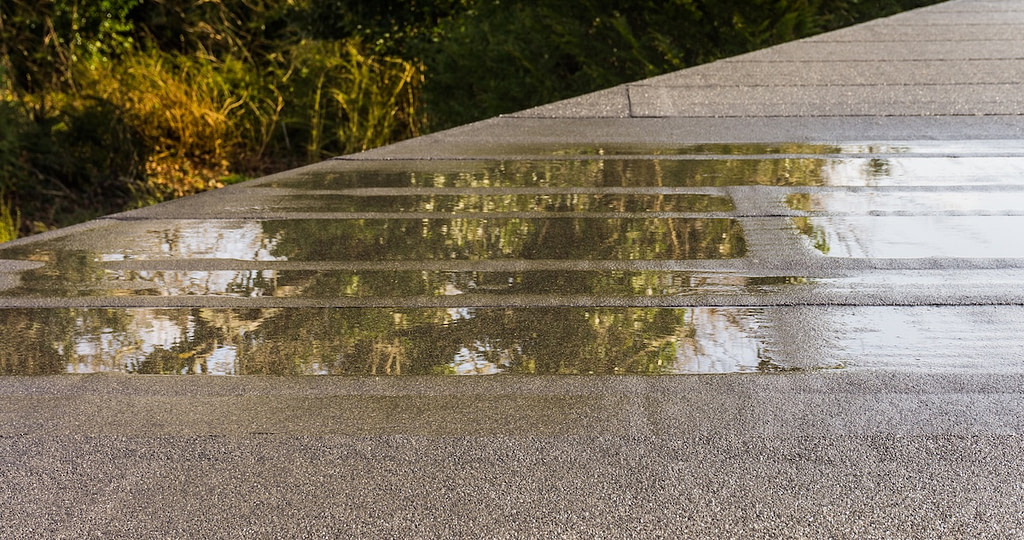 Flat roof with puddle of water close up
