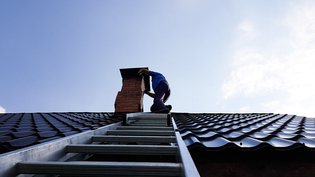 worker fixing chimney