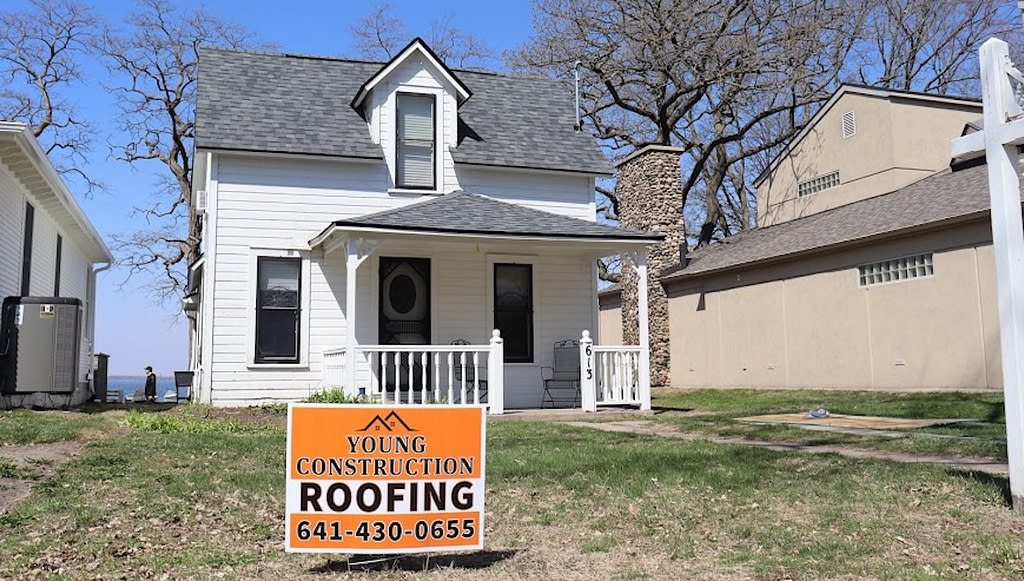 House with Young Construction Roofing sign