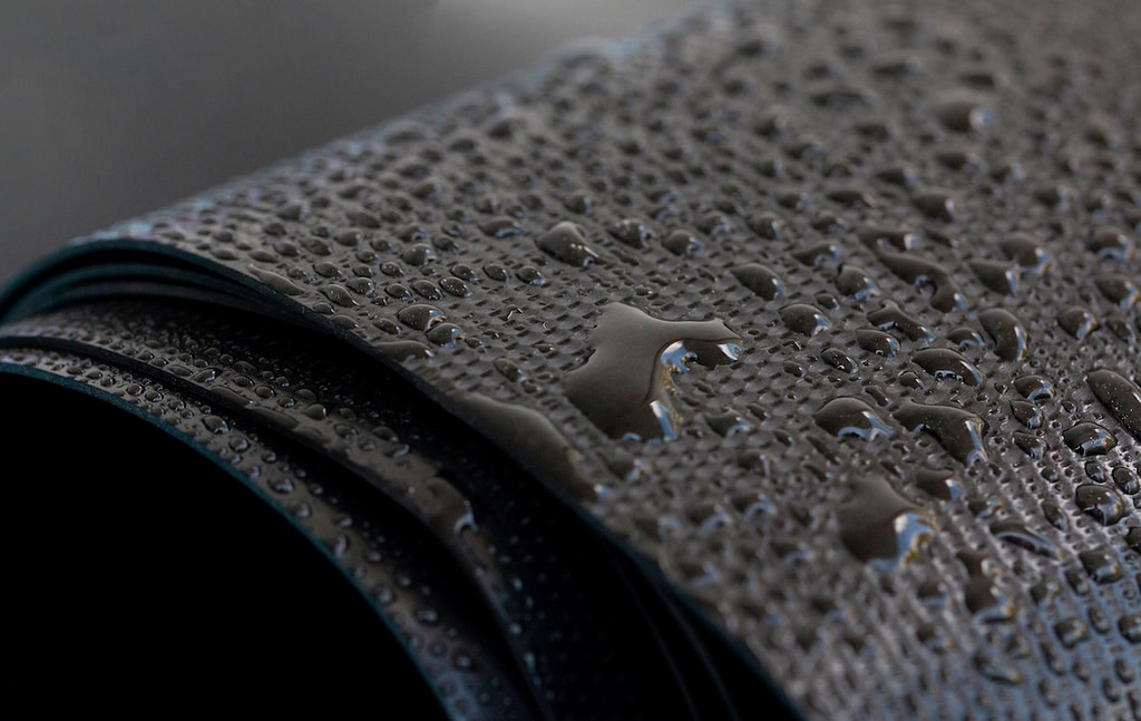 Water droplets on the rubber membrane. Waterproofing... Close-up selective focus area.