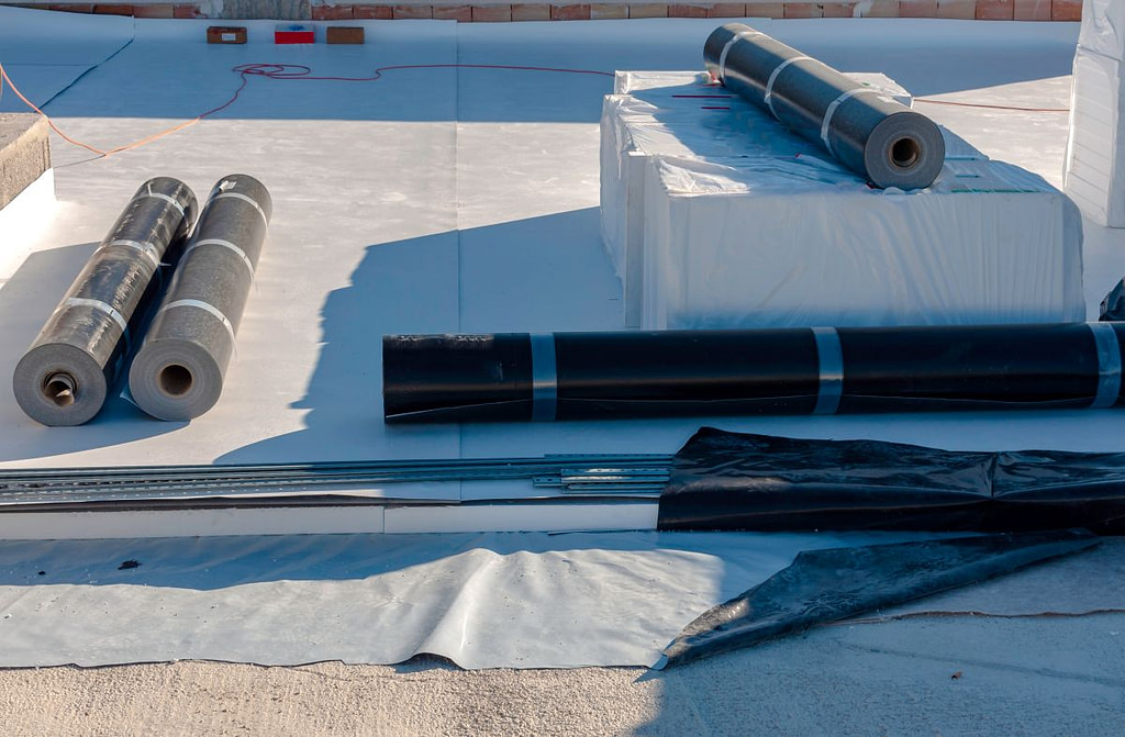 commercial roof installation membranes rolls on top