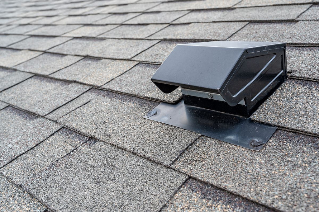 static attic vent on an asphalt shingle roof