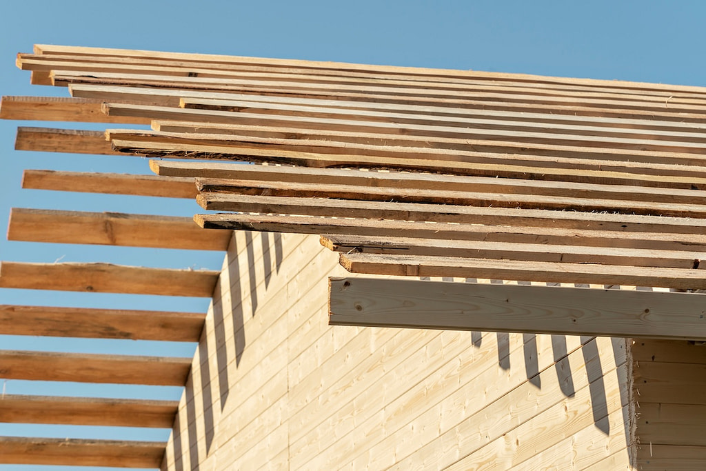 Wooden frame house roof sheathing against clear sky