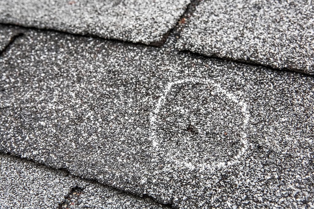 Damage on roof shingle hole