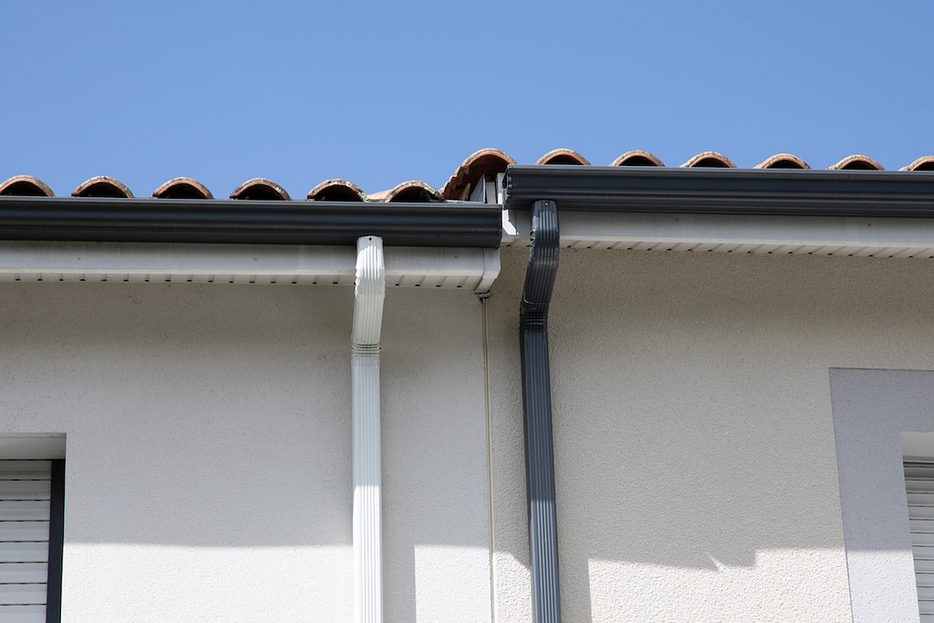grey white edge of roof gutters of semi-detached houses aluminum gutter guard system