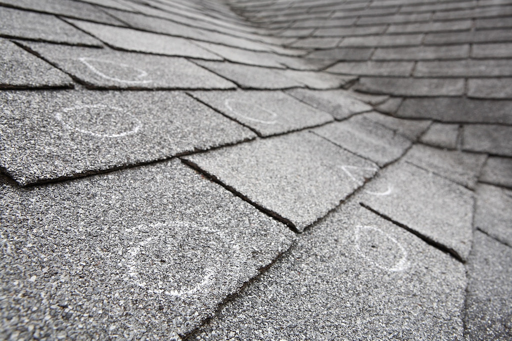 Old roof with hail damaged circled with chalk