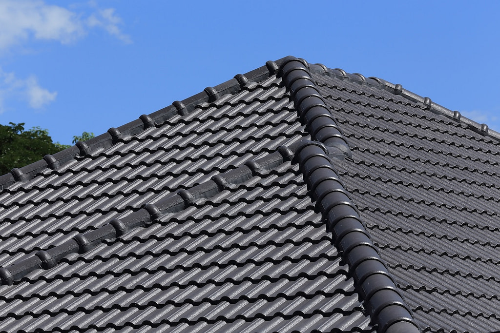 black tiles roof on a new house with blue sky
