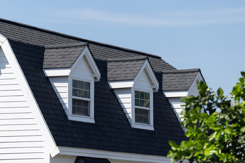 A house with a black roof and white trim.