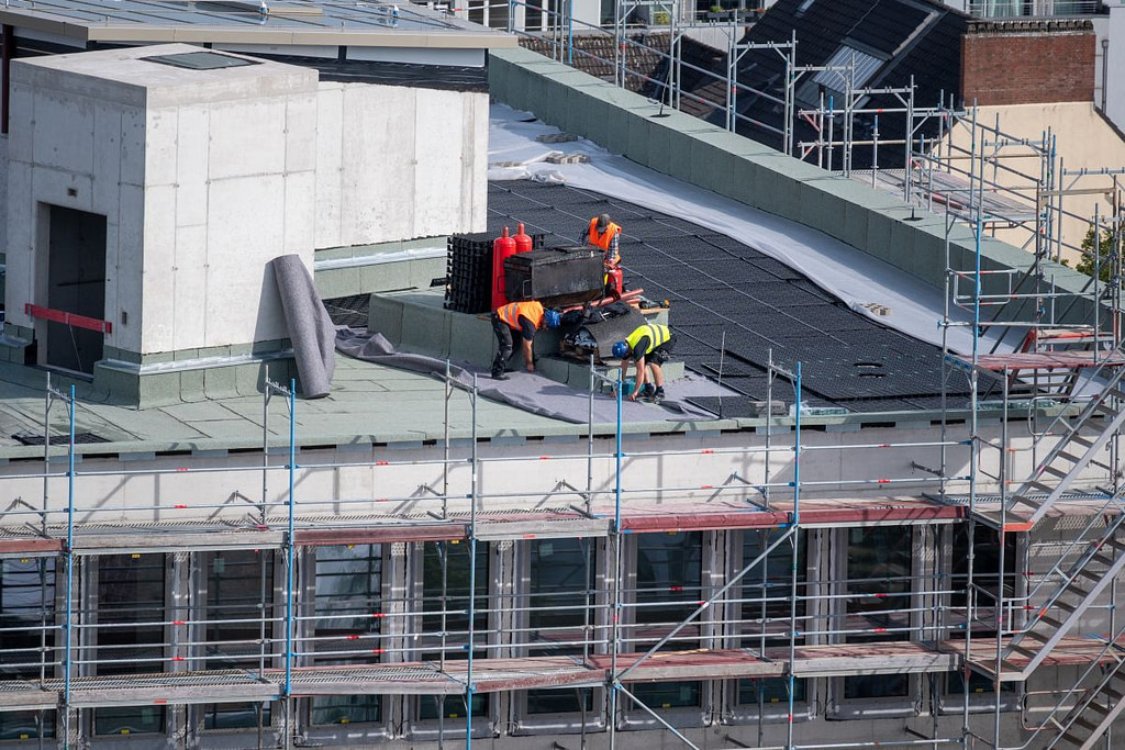 construction workers repairing a commercial roof