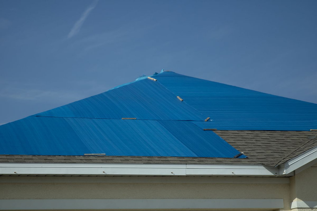 roof covered in a blue tarp