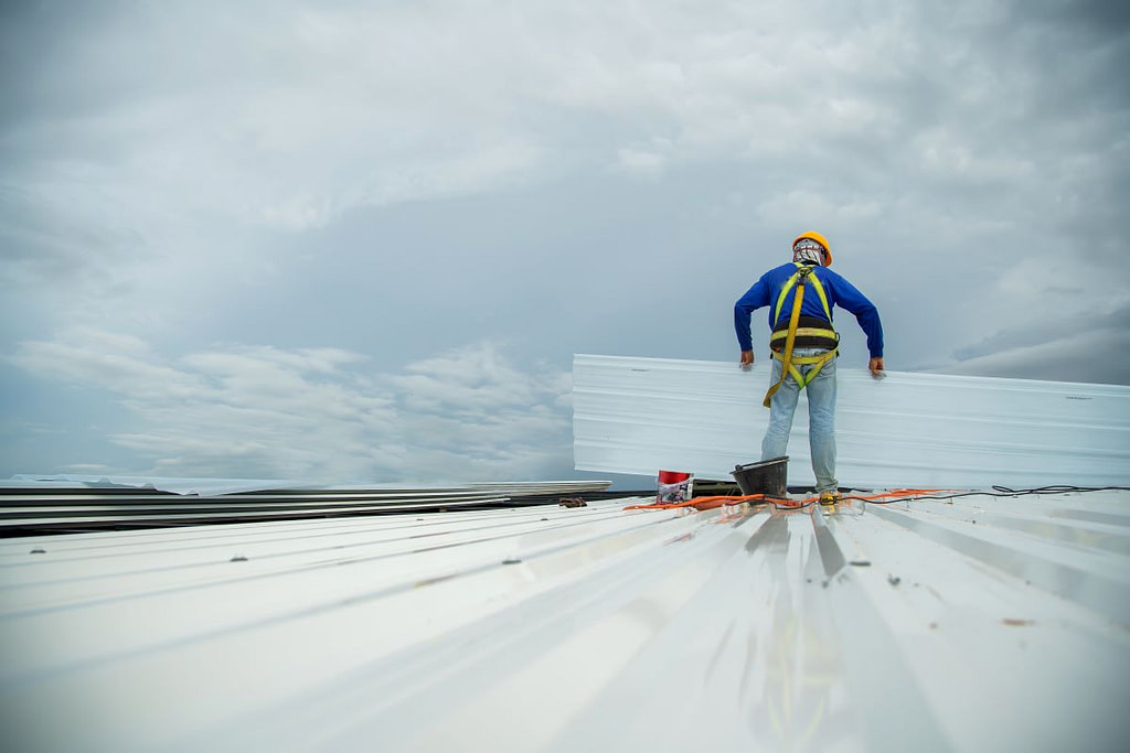 commercial roof repair by construction worker