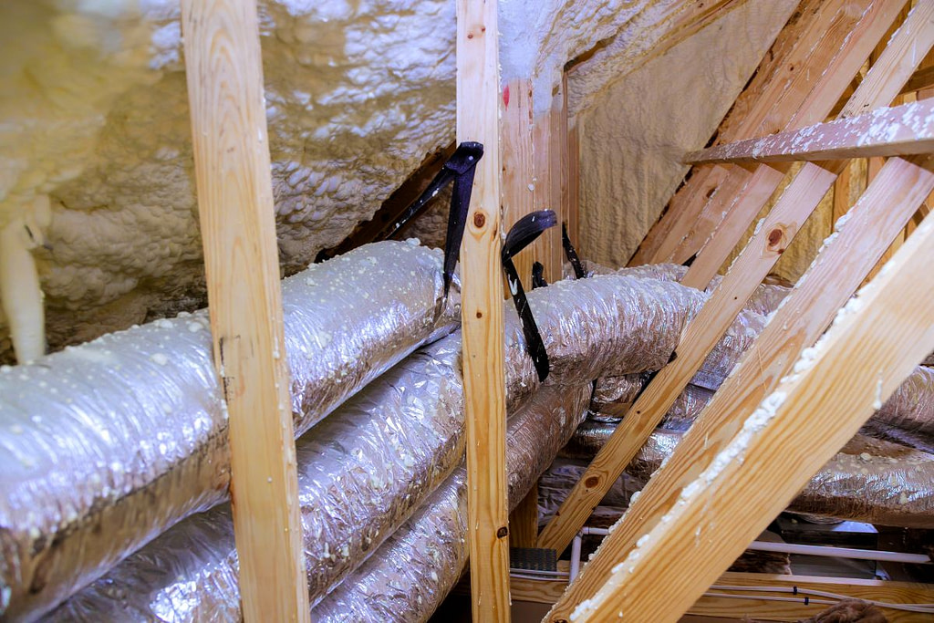 Install silver insulated ducting in attic of home