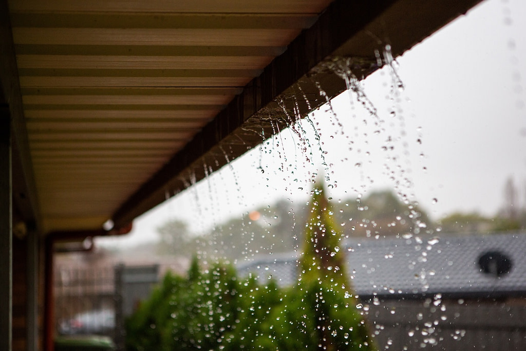 Overflowing house gutters in winter