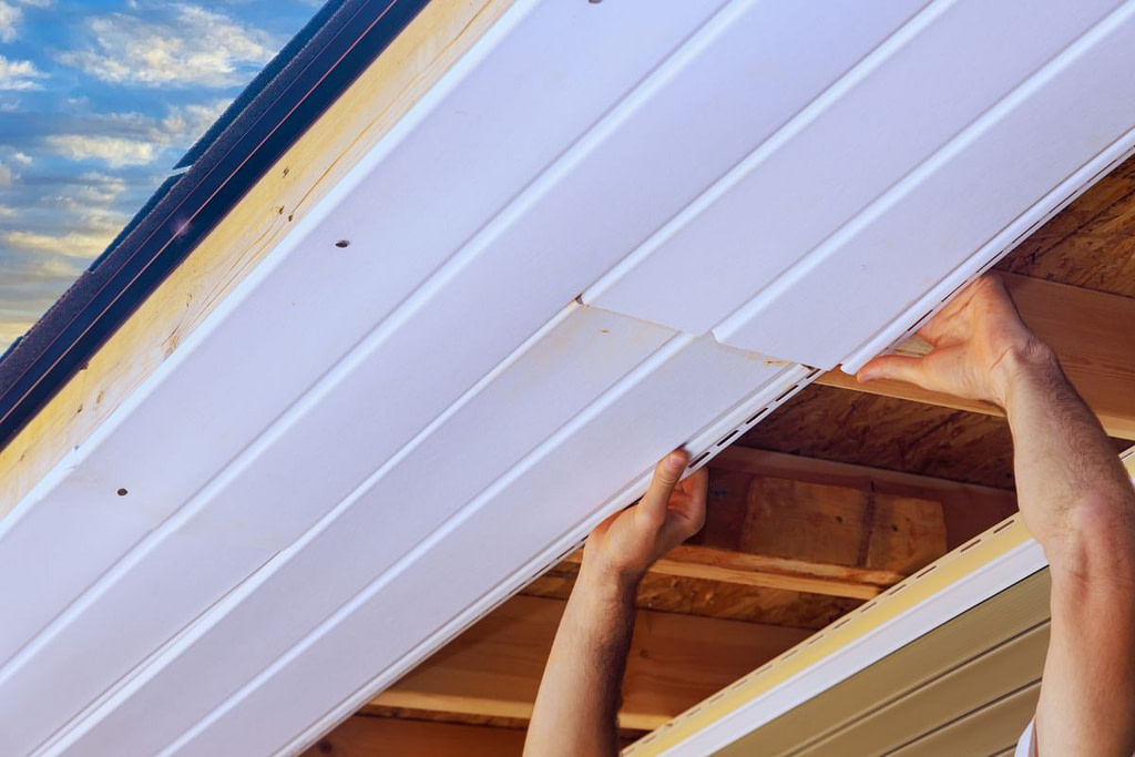 how to install soffit vents worker installing vinyl soffit
