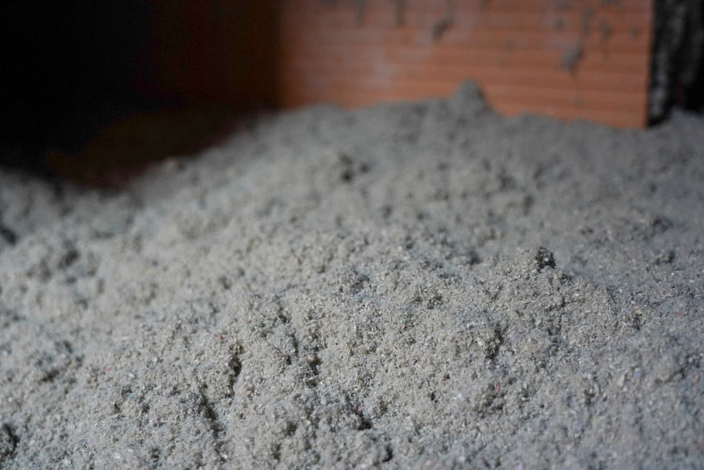 Eco-friendly cellulose insulation for attic. House heat preservation and energy saving