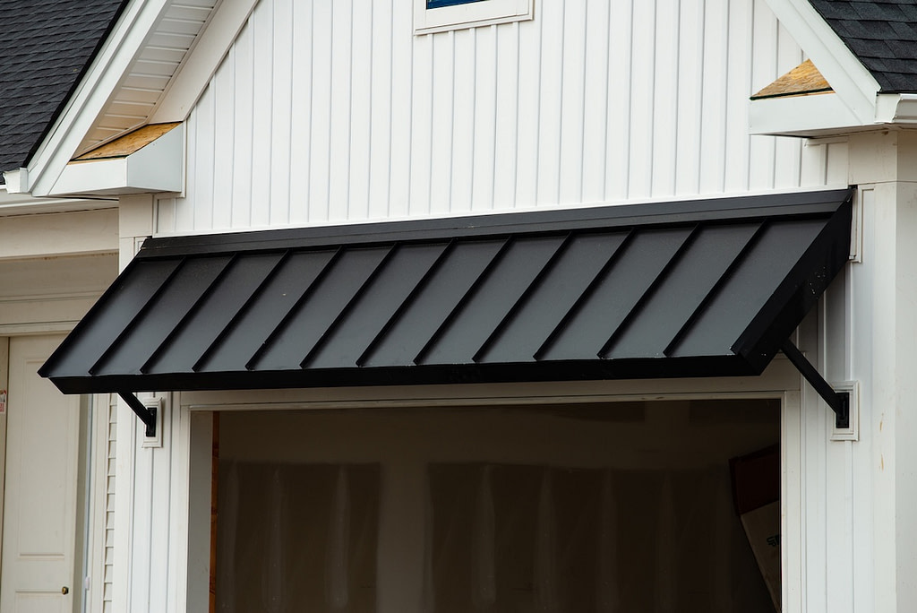 black metal awning above door